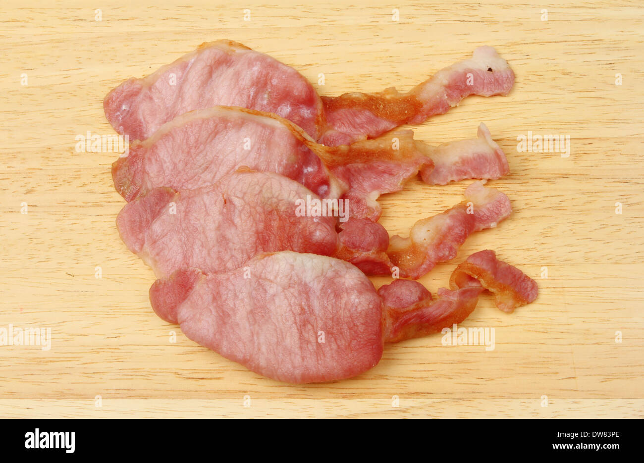 Cooked bacon rashers on a wooden board Stock Photo