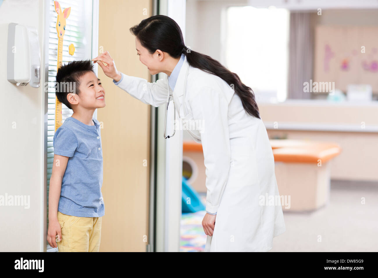 Doctor measuring boy's height Stock Photo
