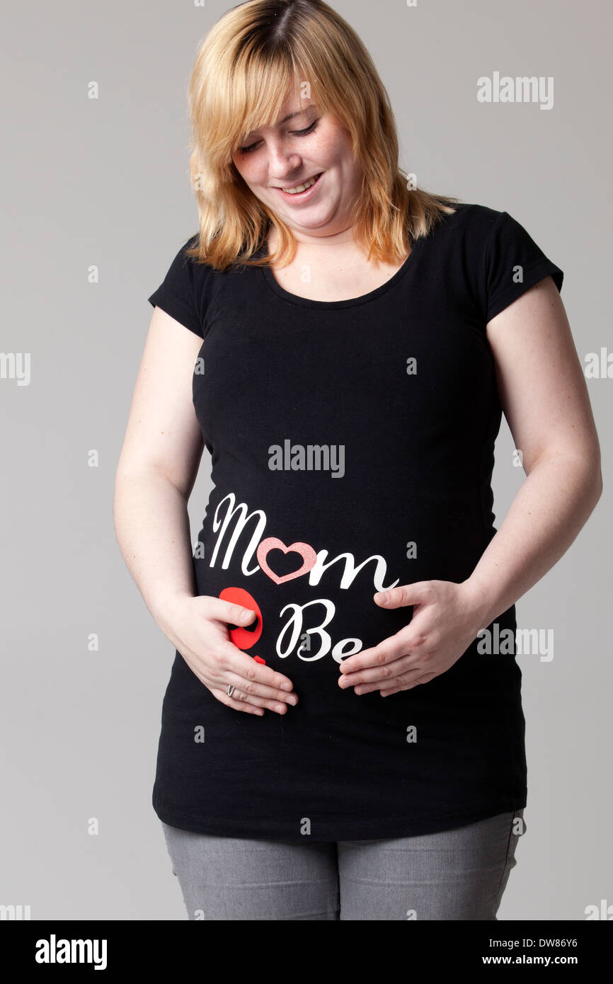 Happy young pregnant woman in the studio Stock Photo