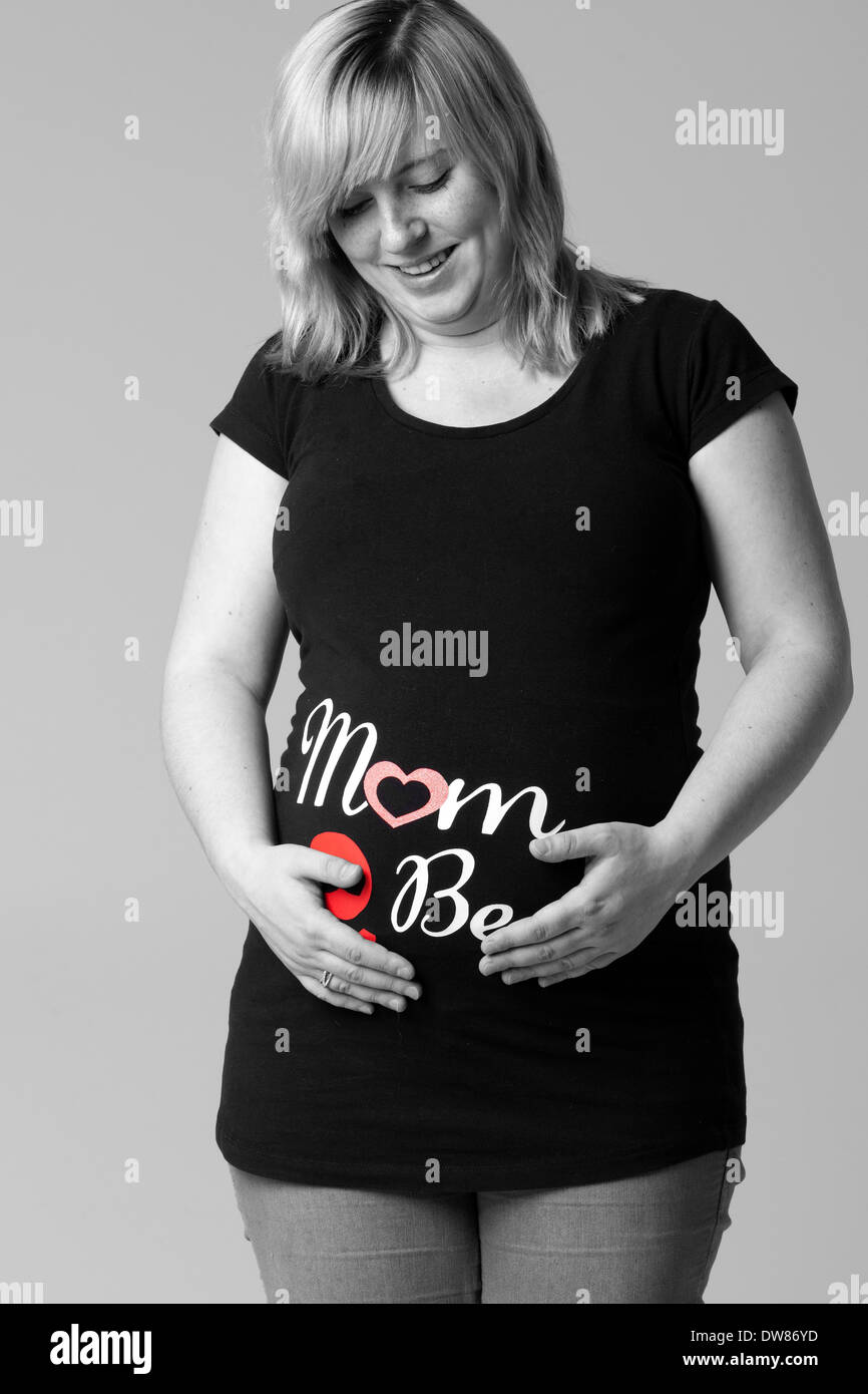 Happy young pregnant woman in the studio Stock Photo