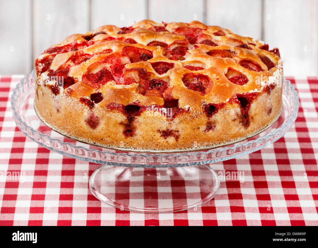 Strawberry pie on cake stand, checkered red table clothStrawberry pie on cake stand, checkered