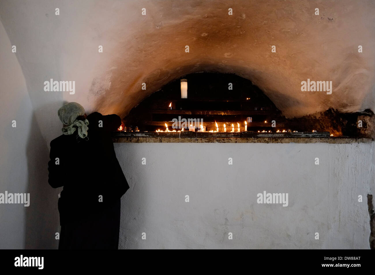 A Jewish worshiper lighting candles at the site of King David tomb in