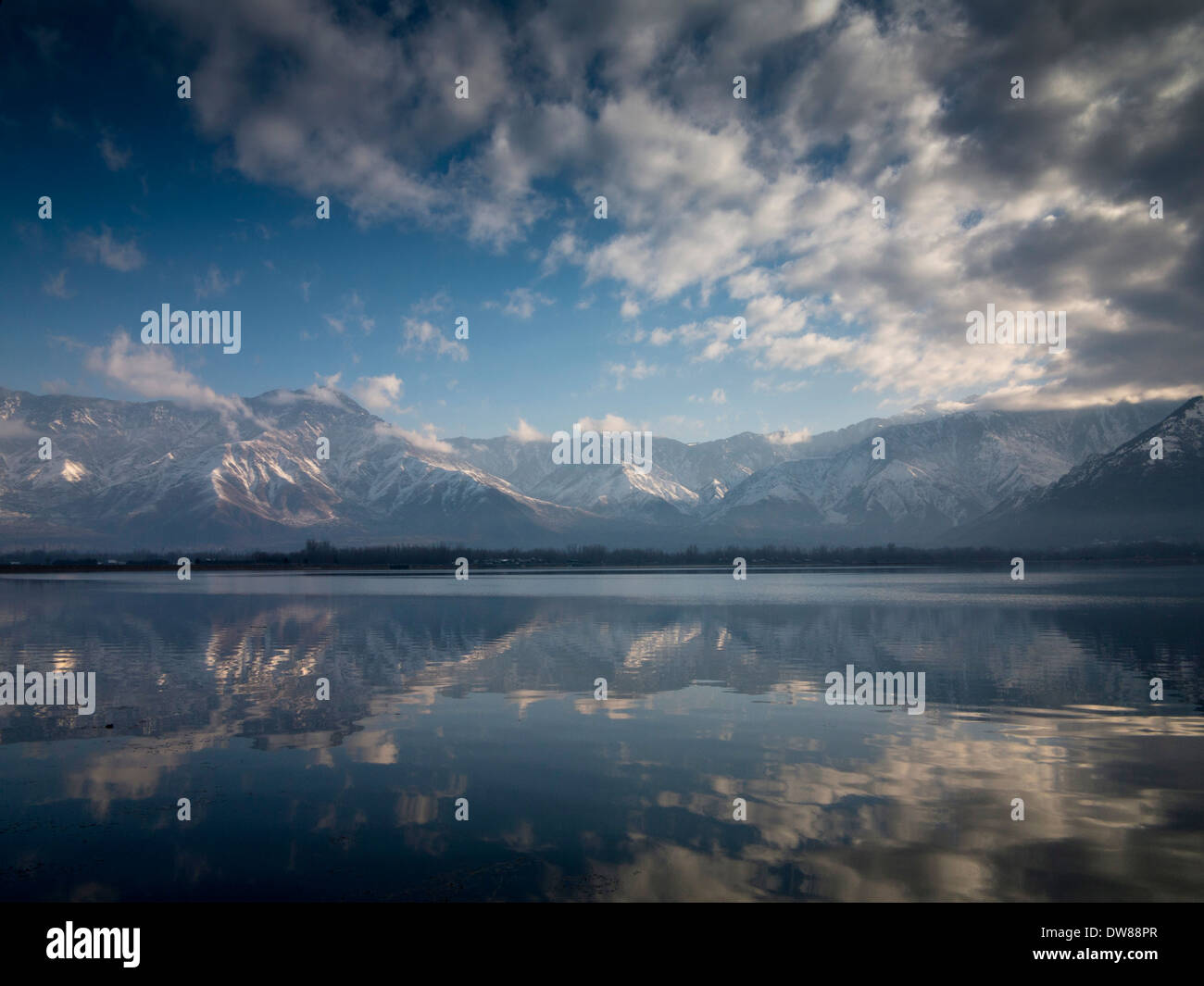 India, Kashmir, Srinagar, winter snow covered Zabarwan mountains reflected in Dal Lake Stock Photo