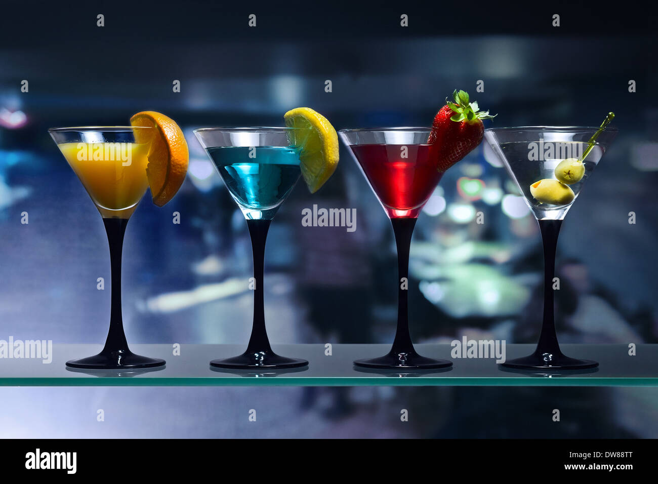 Different Cocktails Garnished With Fruits On Glass Table In Bar Stock different-cocktails-garnished-with-fruits-on-glass-table-in-bar-stock