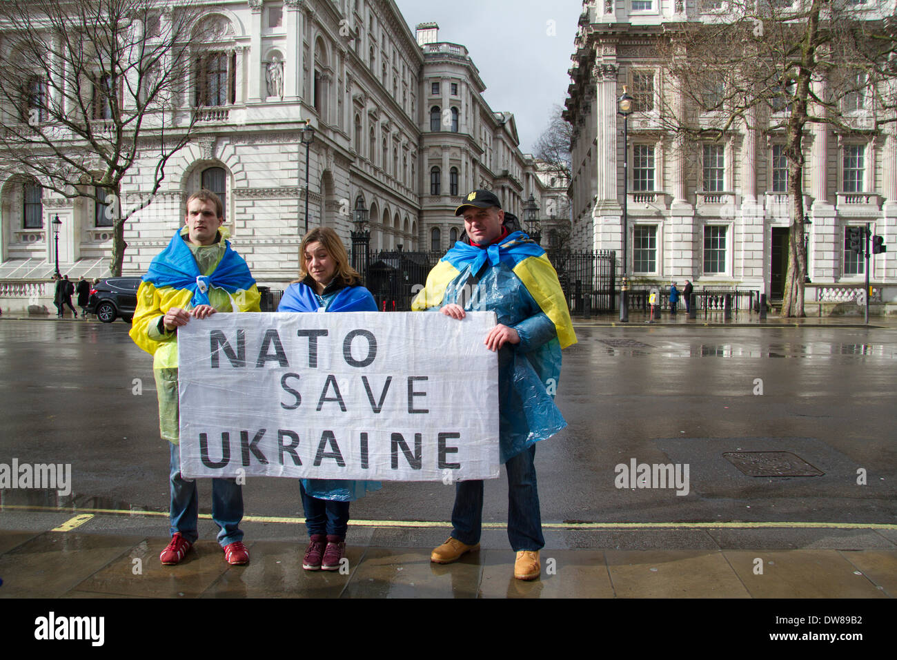 Westminster London,UK 3rd March 2014. A small group of protesters outside Downing Street hold a placard calling for NATO to save the Ukraine following the Russian military intervention in Crimea Credit:  amer ghazzal/Alamy Live News Stock Photo