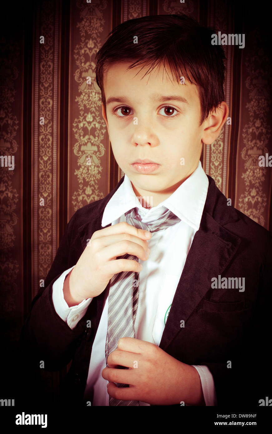 Boy in vintage black suit and tie Stock Photo