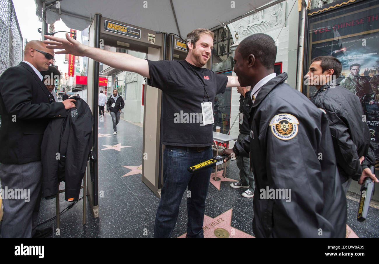 Los Angeles, CA, USA. 3rd March, 2014. A security officer screens a media member at a security post on the Hollywood Walk of Fame before the 86th Academy Awards in Los Angeles, the United States, March 2, 2014. Credit:  Xinhua/Alamy Live News Stock Photo
