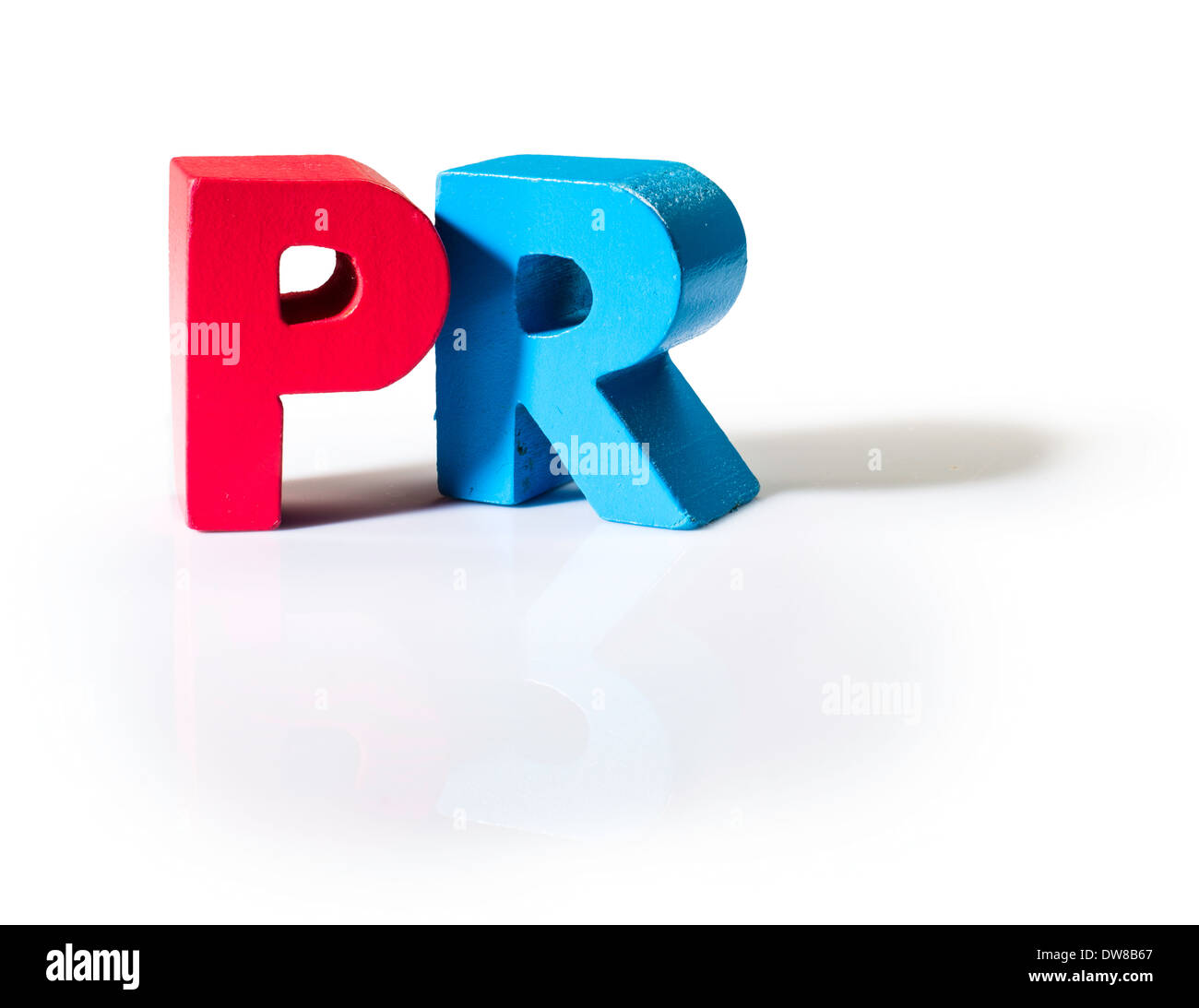 Multicolored text PR made of wood. White background Stock Photo