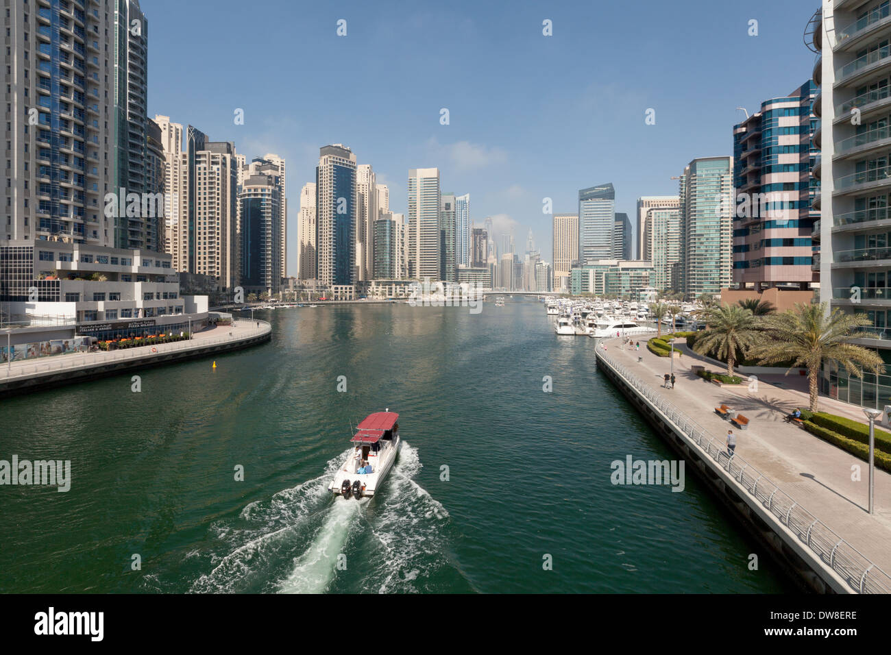 A boat entering Dubai Marina, Jumeirah towers area, Dubai, UAE, United Arab Emirates Middle East Stock Photo