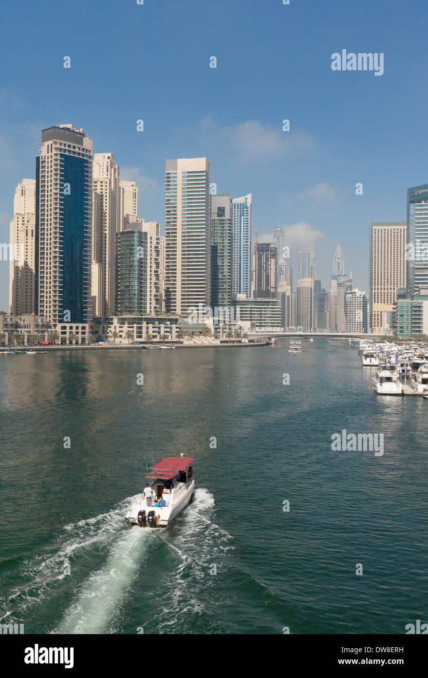 A boat entering Dubai Marina, Jumeirah towers area, Dubai, UAE, United Arab Emirates Middle East Stock Photo