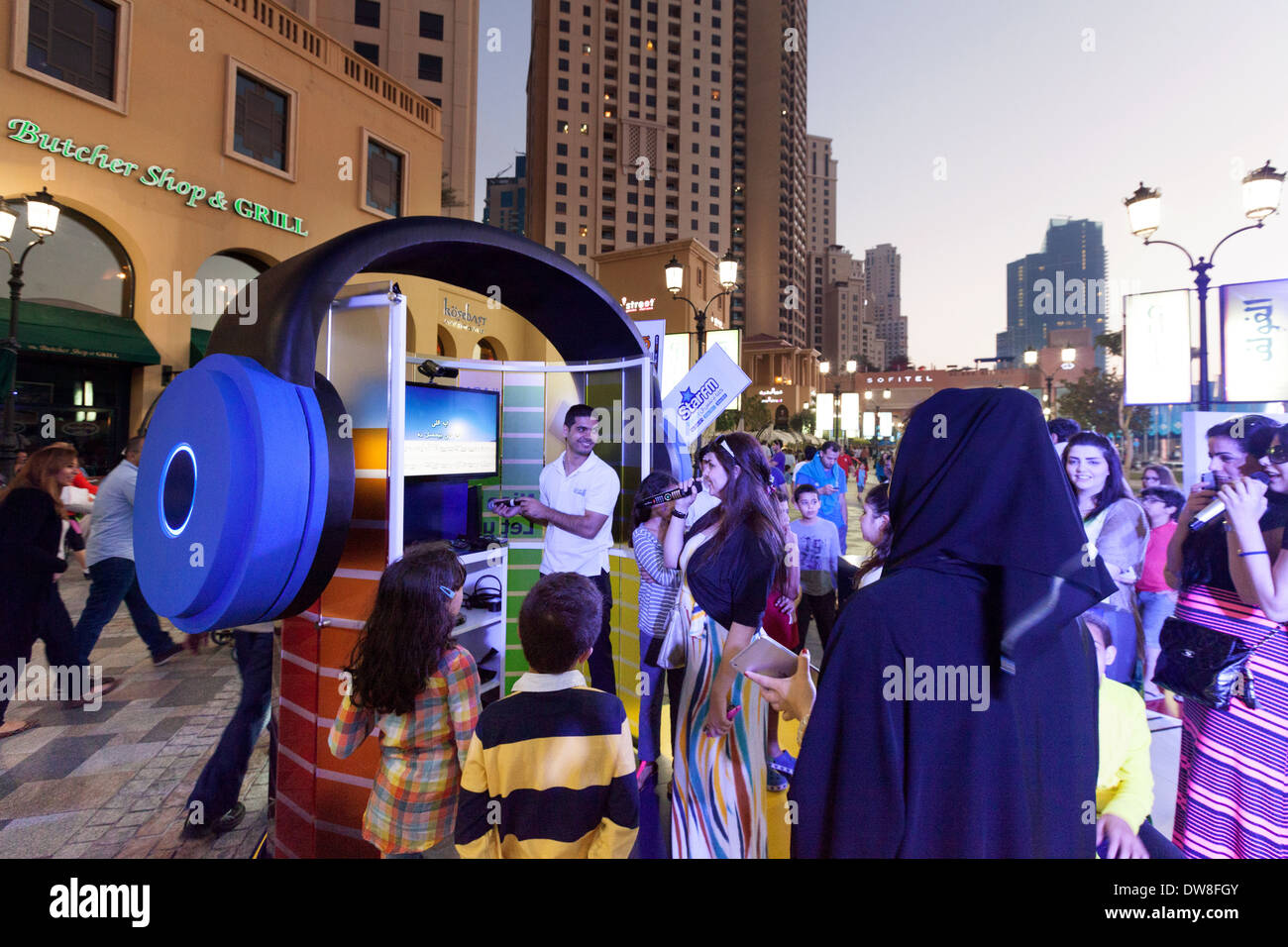 Dubai arab children and teens singing karaoke at an outdoor media