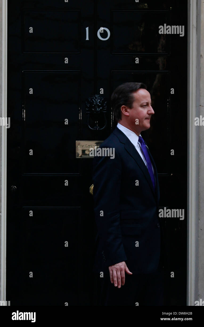 Prime Minister David Cameron walks out of Downing Street to pose for photographs with young athletes on March 28, 2012 in London, England. The young athletes will compete in the finals of the School Games later this year, which is a mirror version of the Olympics for young people. (Photo by Tal Cohen) Stock Photo