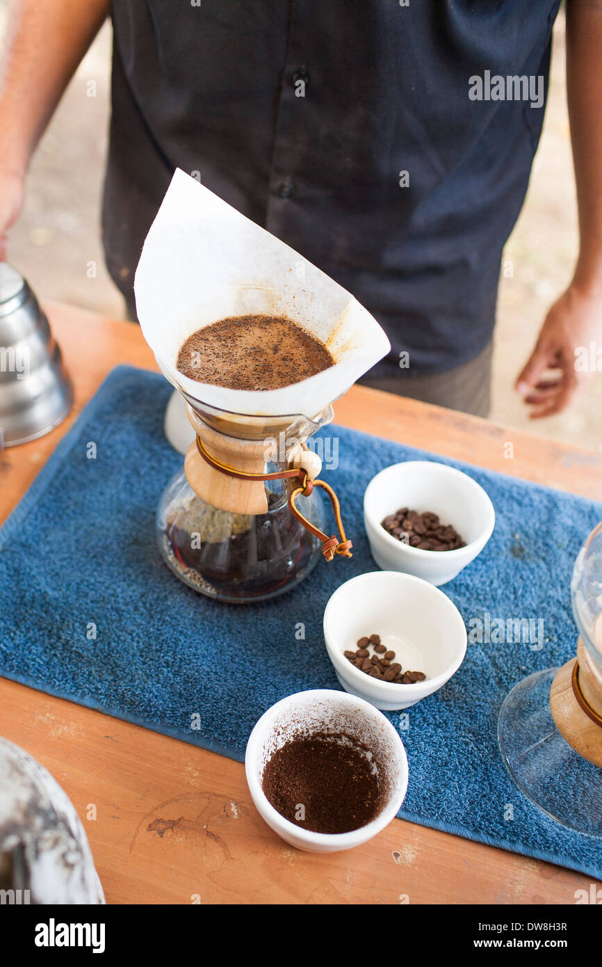Making a carafe of freshly roasted brewed coffee using a Chemex coffeemaker at a roasting facility in Juayua El Salvador Stock Photo