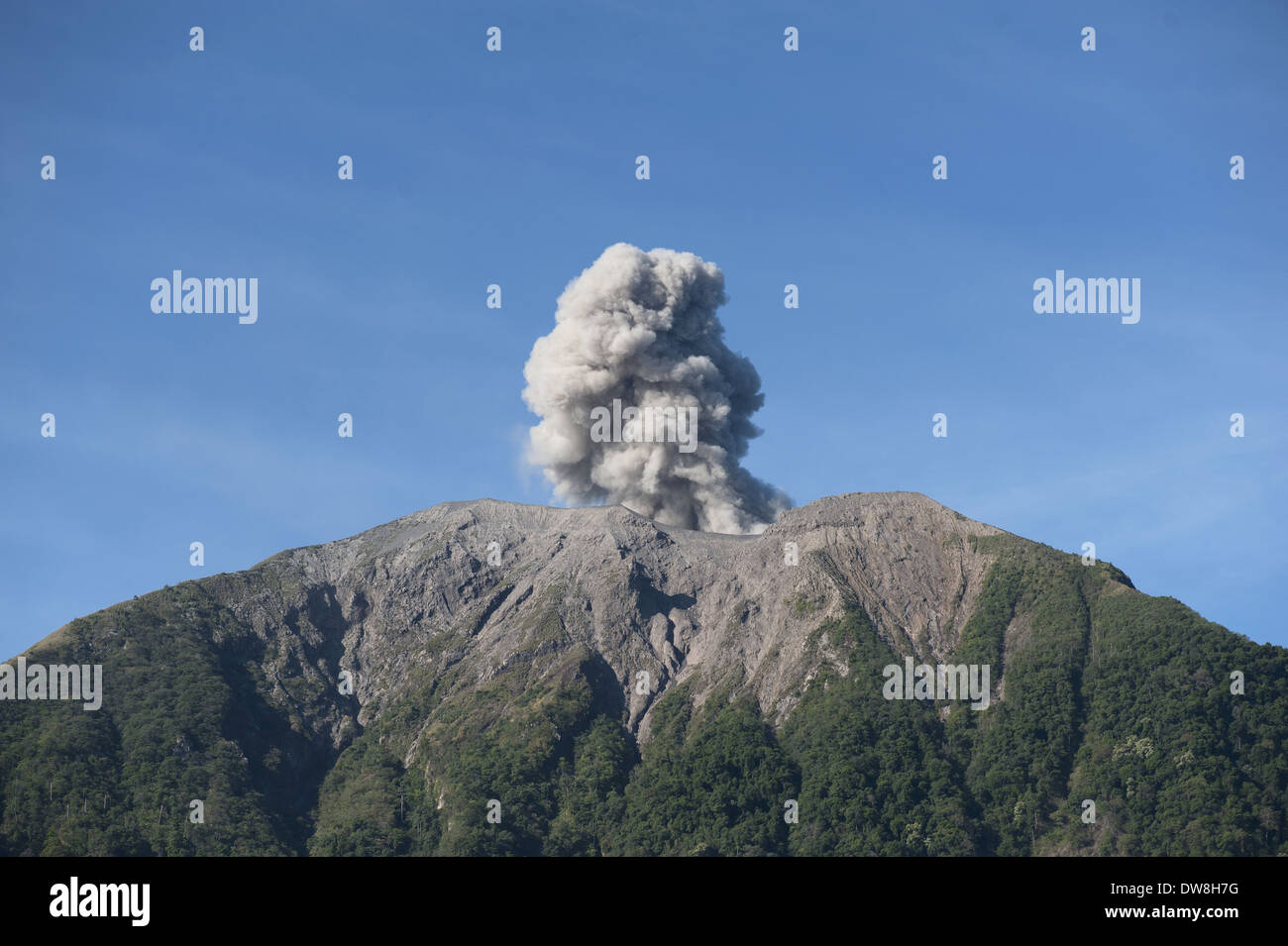 Volcanic eruption with ash plume Mount Komba Alor Archipelago Lesser Sunda Islands Indonesia November 2013 Stock Photo