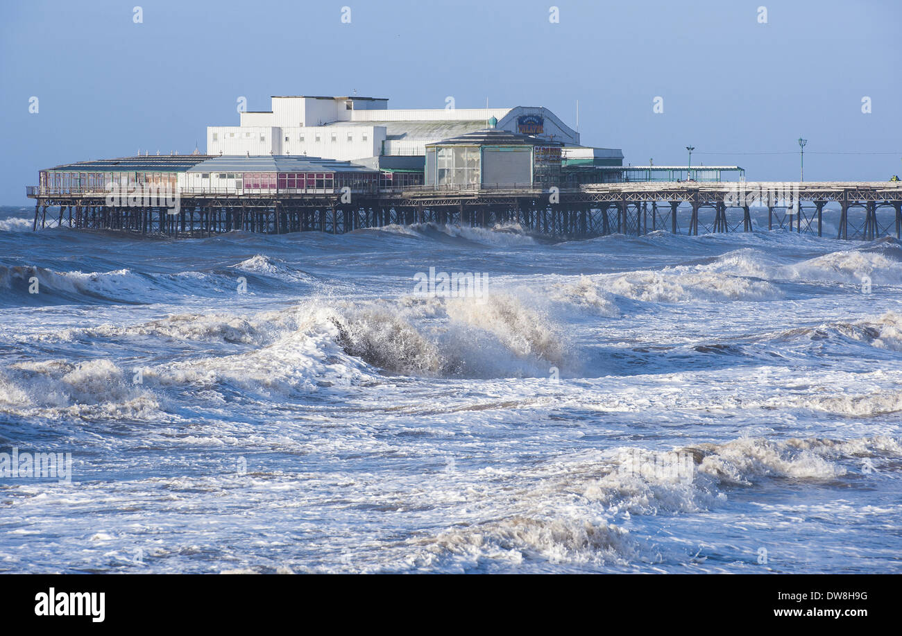 Stormy sea and Victorian pier in seaside resort town North Pier Blackpool Lancashire England January Stock Photo