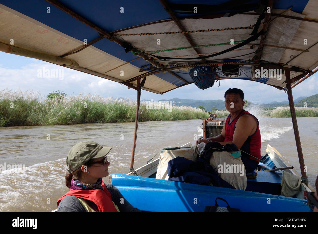 Driving a long-tail boat on the Nam Kok River, Thailand. Stock Photo