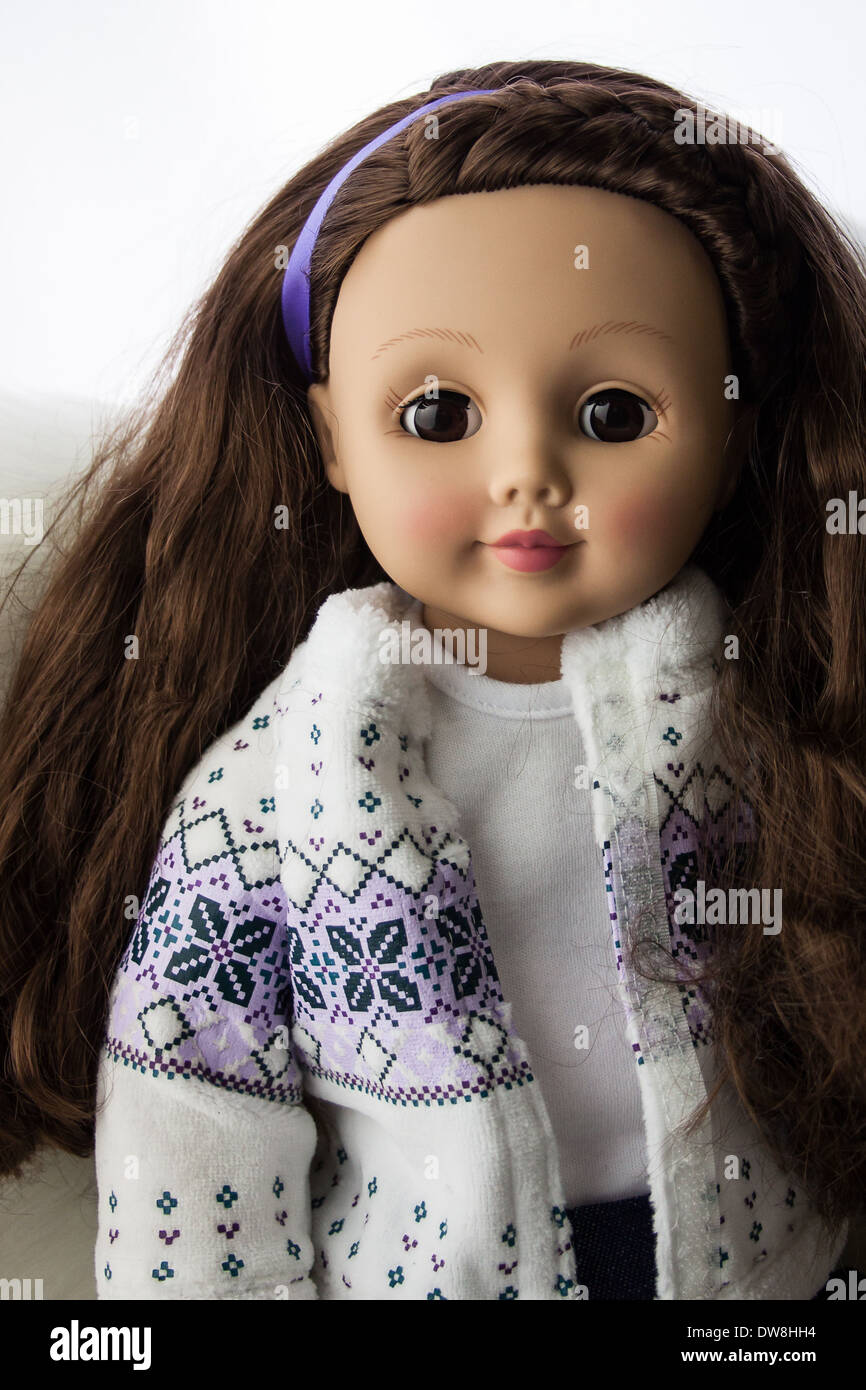 Doll with pretty face, and long brown hair, and round brown eyes, wearing winter sweater Stock Photo