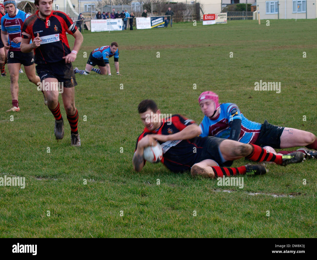 Amateur rugby player sliding over the line to score a try with motion blur, Bude, Cornwall, UK Stock Photo