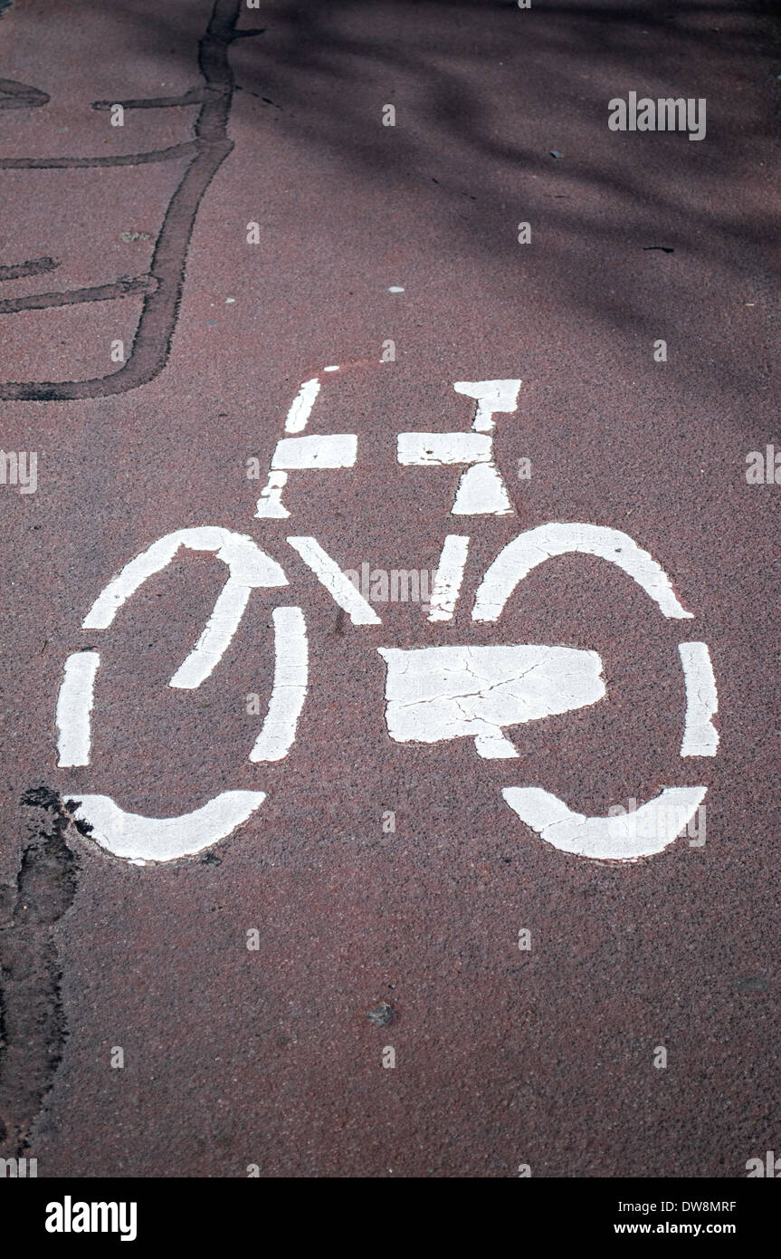 Painted road sign indicating a cycling lane Stock Photo