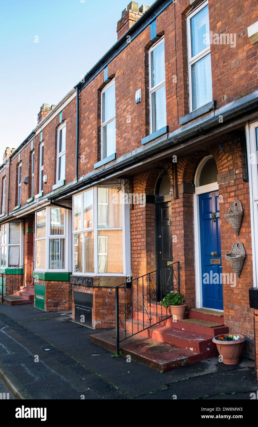 The exterior of a row of Victorian brick built terraced houses in Stretford, Manchester, England, UK Stock Photo