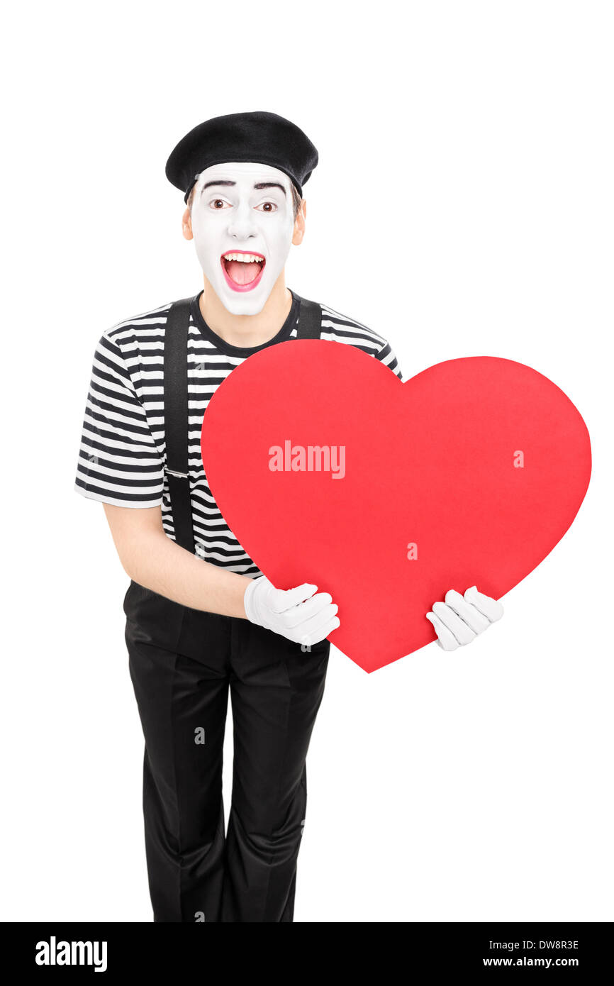 Male mime artist holding a big red heart Stock Photo