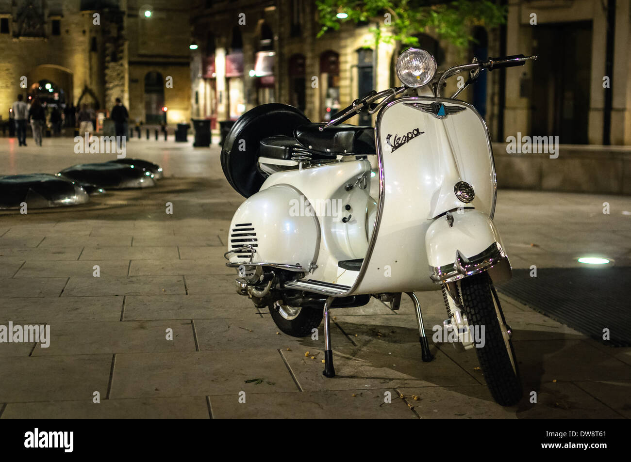 Old Vespa parked at night in Bordeaux city center. Stock Photo