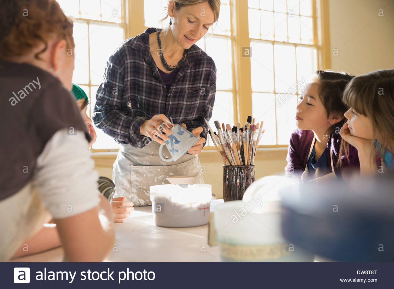 Students watching instructor explain glazing techniques Stock Photo