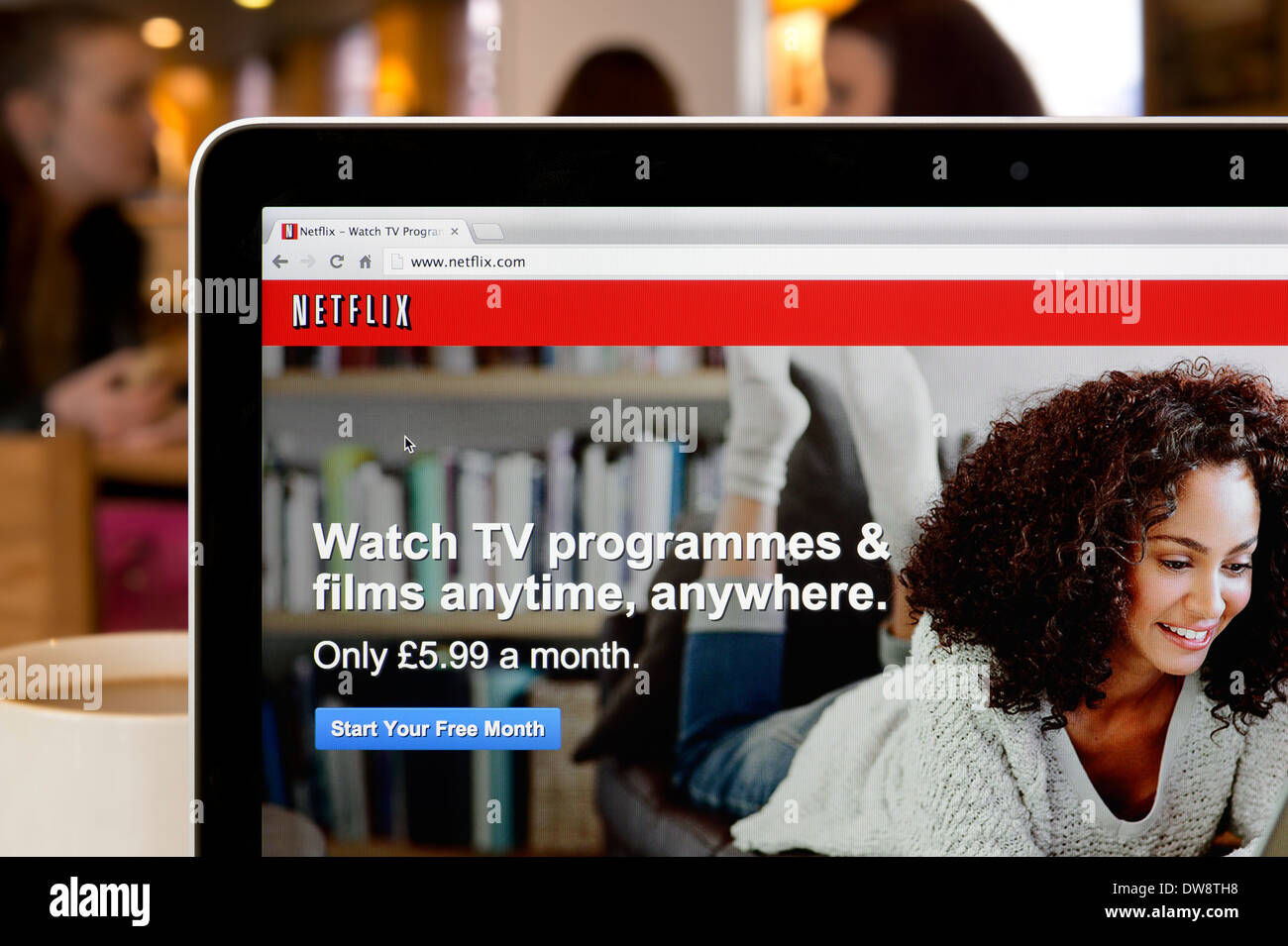 The Netflix website shot in a coffee shop environment (Editorial use only: print, TV, e-book and editorial website). Stock Photo