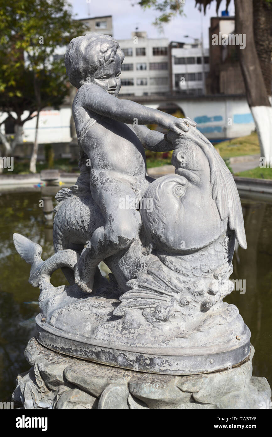 Statue of a boy sitting on a fish in the fountain in Parque Sucre, Riobamba, Ecuador Stock Photo