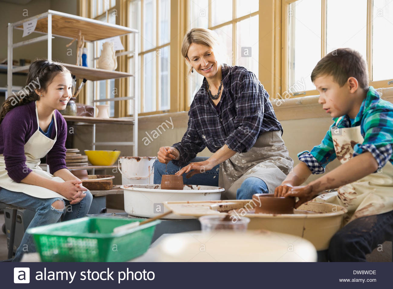 Teacher with students in pottery class Stock Photo Alamy