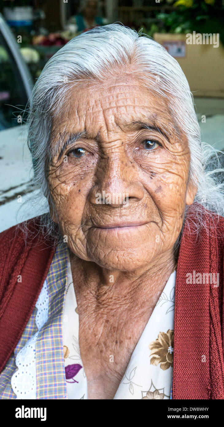 proud humble immaculate wrinkled 101 year old Mexican indigenous Indian woman vendor working at mercado La Merced market Oaxaca Stock Photo