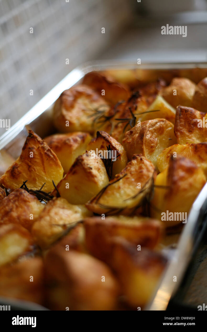Golden crisp roast potatoes roasting tray hires stock photography and