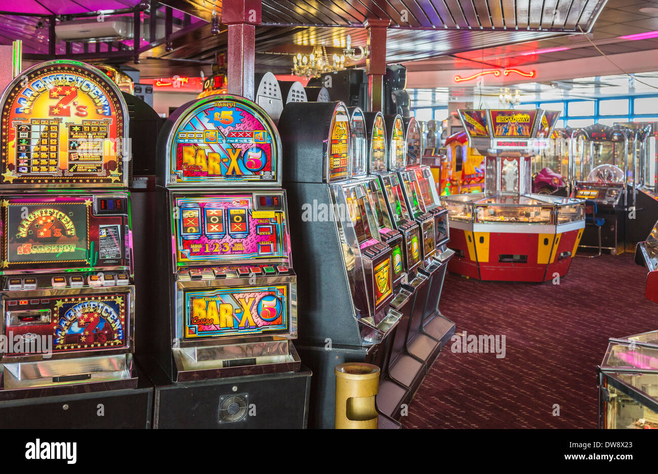 Brightly coloured slot, gaming and fruit machines in amusement arcade