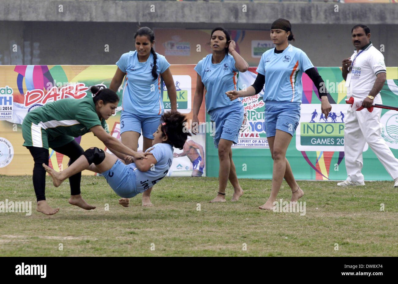 Lahore. 3rd Mar, 2014. A Pakistan kabaddi player (L) tackles an Indian opponent during a Punjab Youth Festival kabaddi match in eastern Pakistan's Lahore on March 3, 2014. India won the match against Pakistan, scoring 38-15. © Sajjad/Xinhua/Alamy Live News Stock Photo
