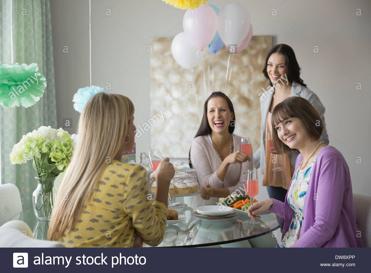 Female friends enjoying baby shower Stock Photo