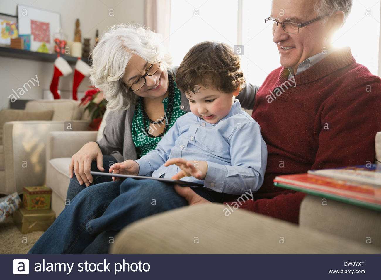 Grandparents and grandson using digital tablet together Stock Photo