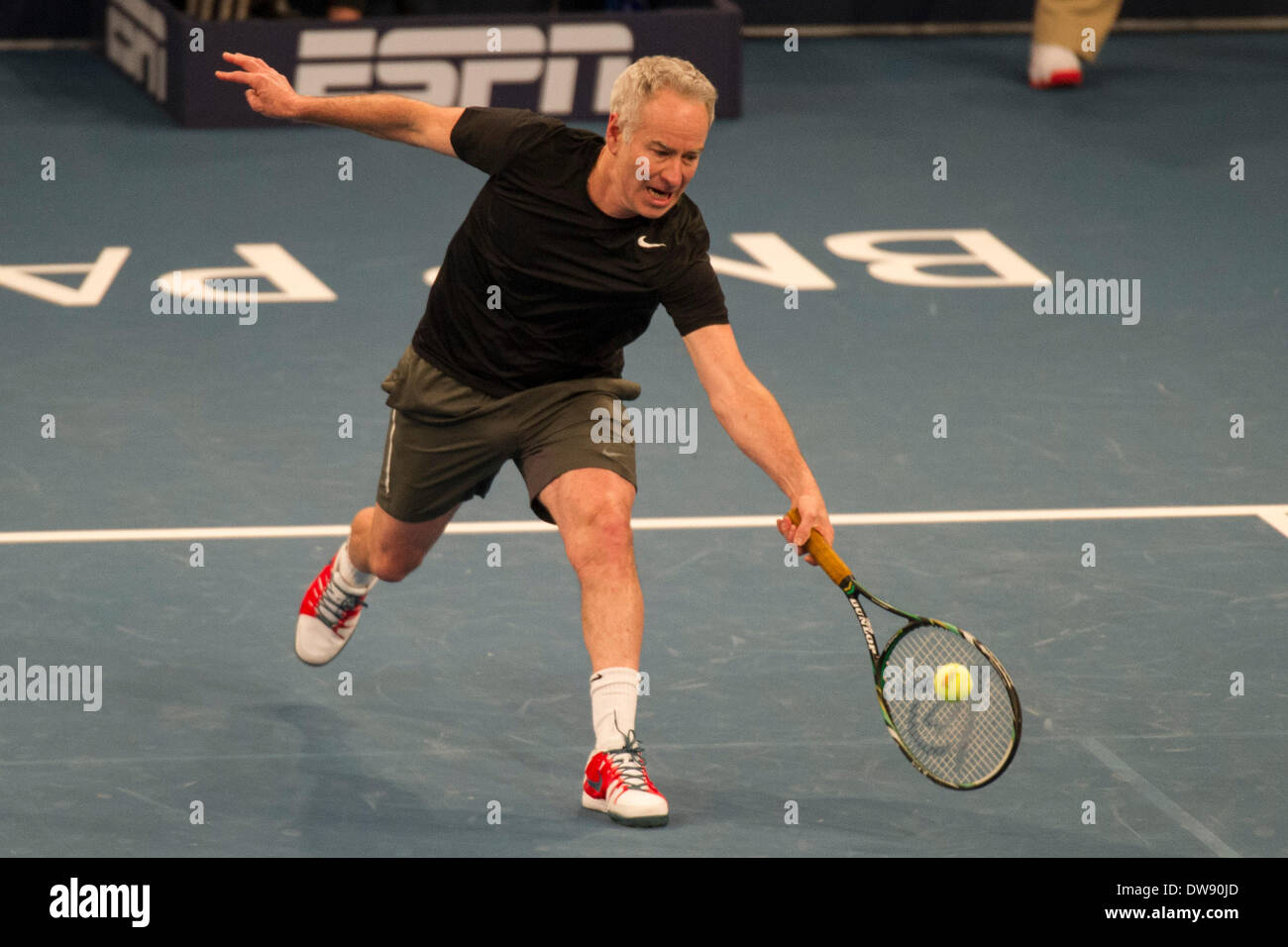 Manhattan, New York, USA. 3rd Mar, 2014. March 03, 2014: John McEnroe reaches for a volley during the BNP Paribas Showdown on World Tennis Day at Madison Square Garden in Manhattan, New York. Credit:  csm/Alamy Live News Stock Photo