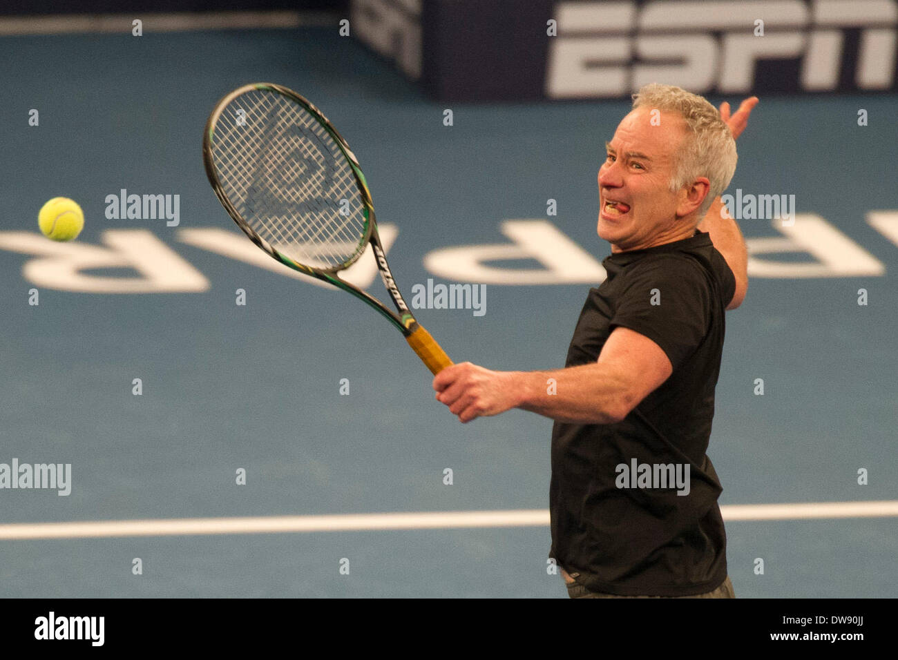 Manhattan, New York, USA. 3rd Mar, 2014. March 03, 2014: John McEnroe bites on his tongue as he reaches for a volley during the BNP Paribas Showdown on World Tennis Day at Madison Square Garden in Manhattan, New York. Credit:  csm/Alamy Live News Stock Photo