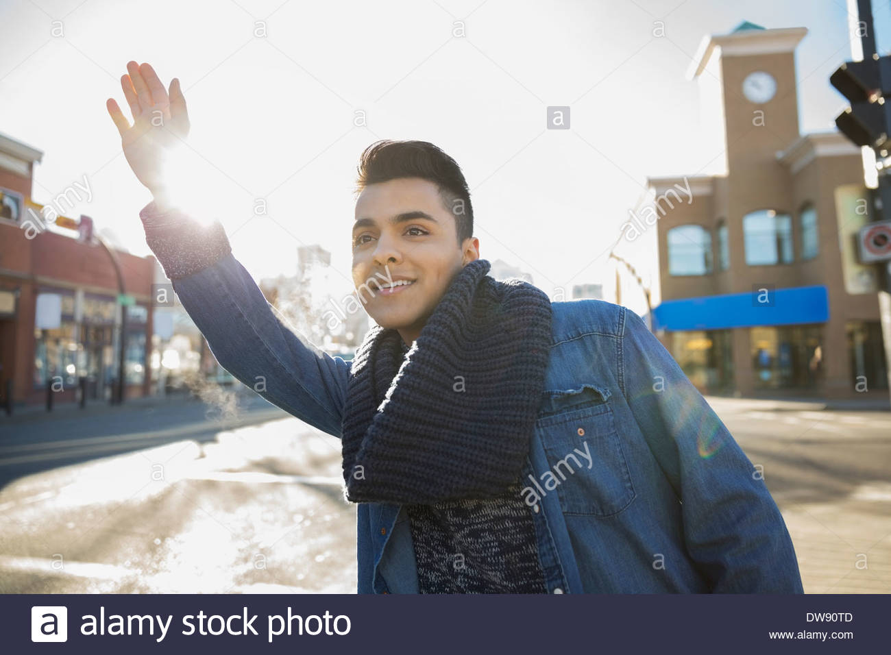 Man hailing taxi on city street Stock Photo