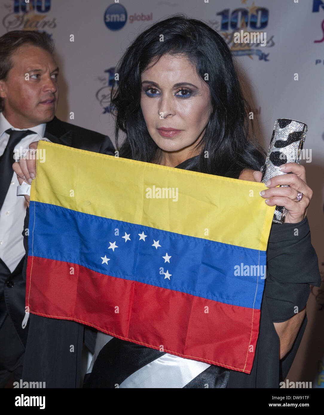 California, USA. 2nd Mar, 2014. Former Miss World 1975 for Venezuela, MARIA CONCHITA ALONSO, born in Cuba and raised in Venezuela, posed with the Venezuelan flag on the red carpet at the Night of 100 Stars 2014 Oscar viewing party on Sunday evening in the Sunset Room of the Beverly Hills Hotel. Credit:  David Bro/ZUMAPRESS.com/Alamy Live News Stock Photo