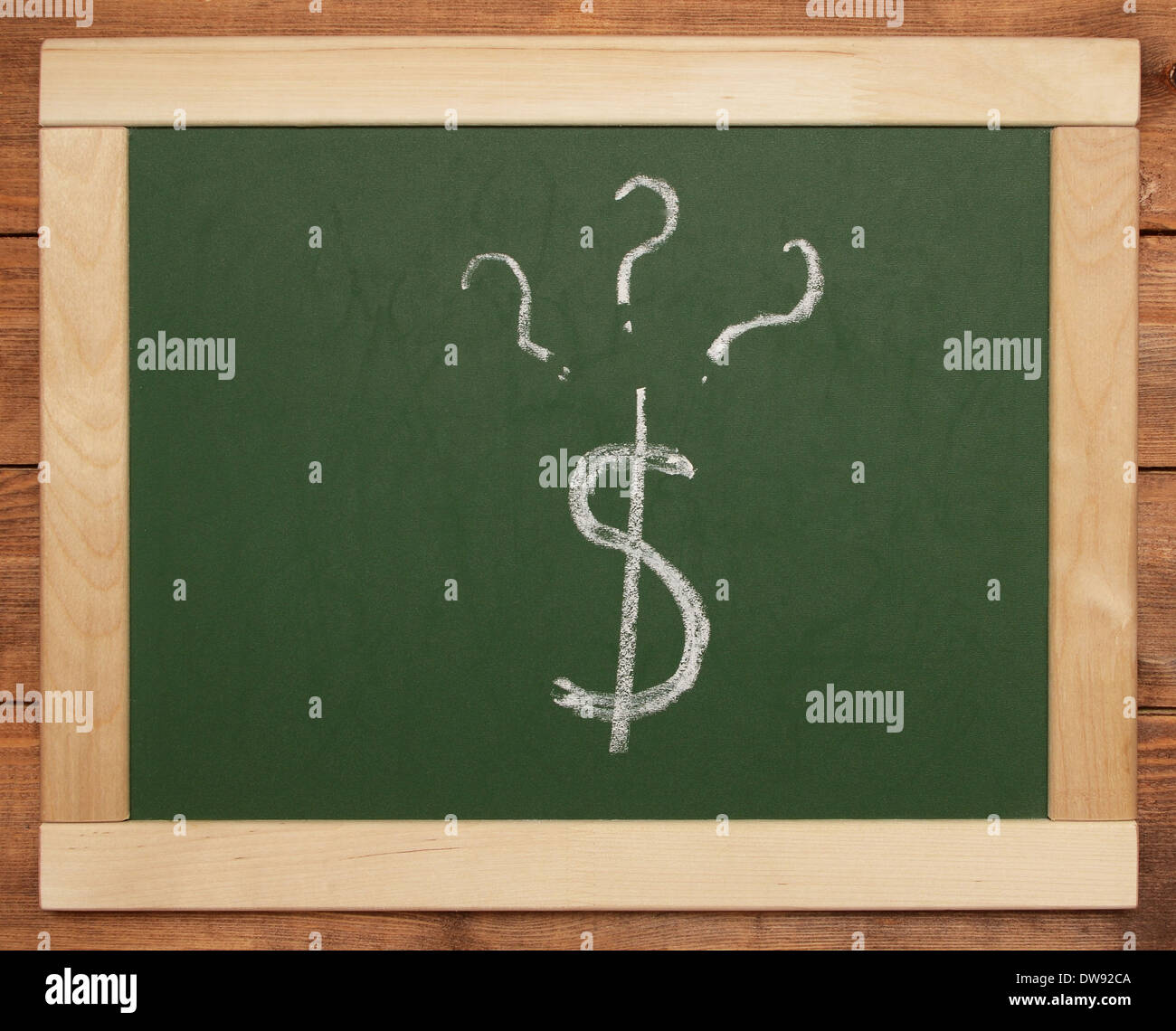 dollar sign and questions on blackboard Stock Photo