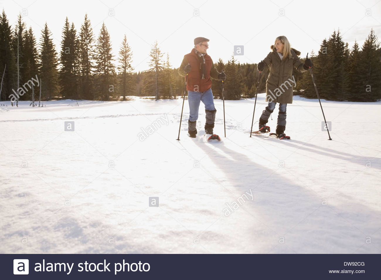 Smiling couple snowshoeing Stock Photo