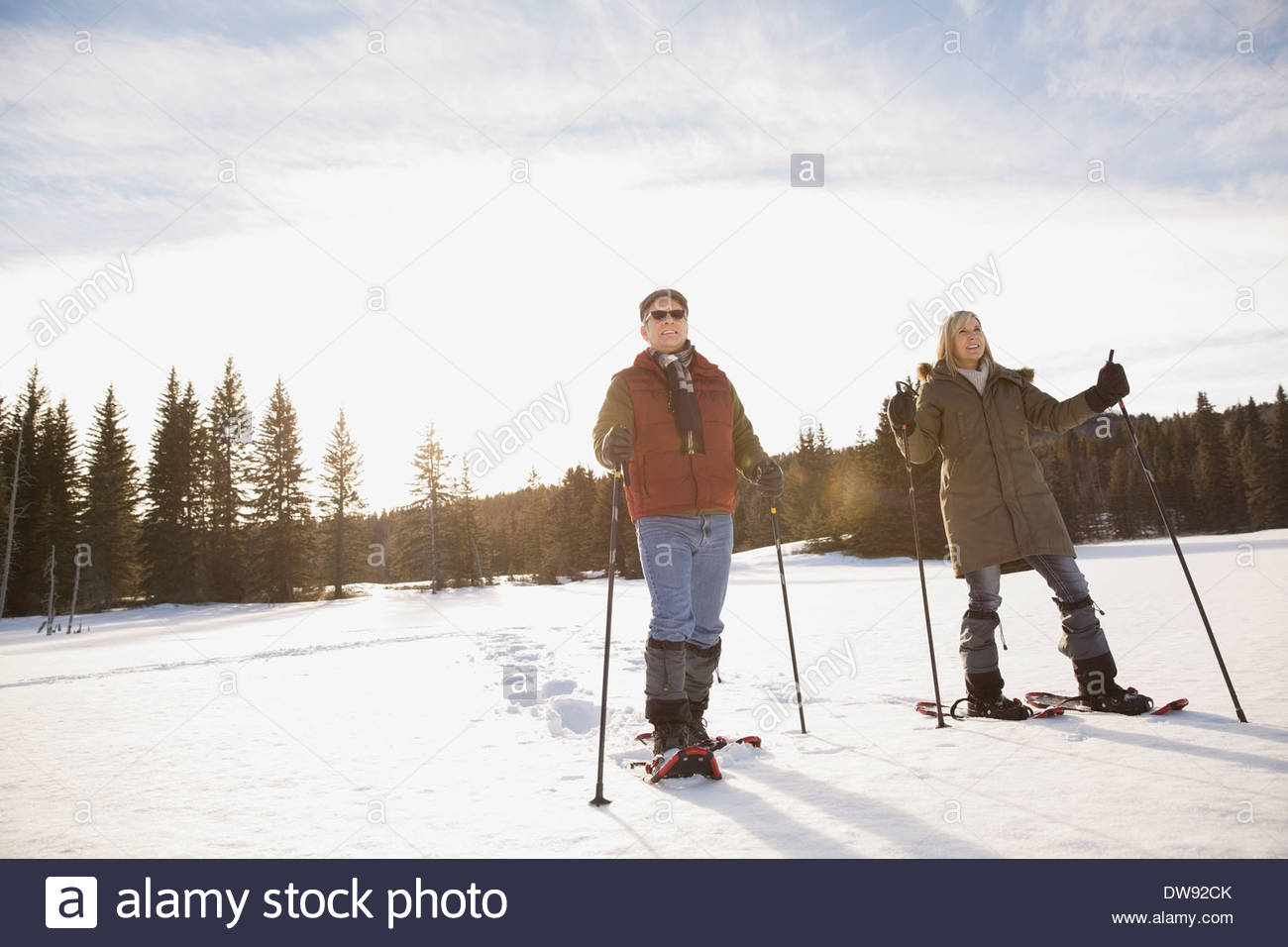 Mature couple snowshoeing Stock Photo