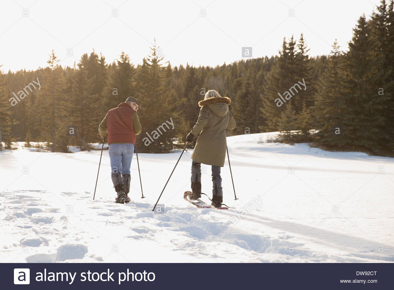 Rear view of couple snowshoeing Stock Photo
