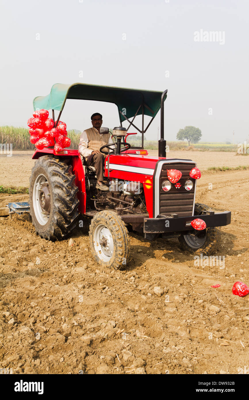 1 Indian farmer driving tractor in Plowed field Stock Photo Alamy
