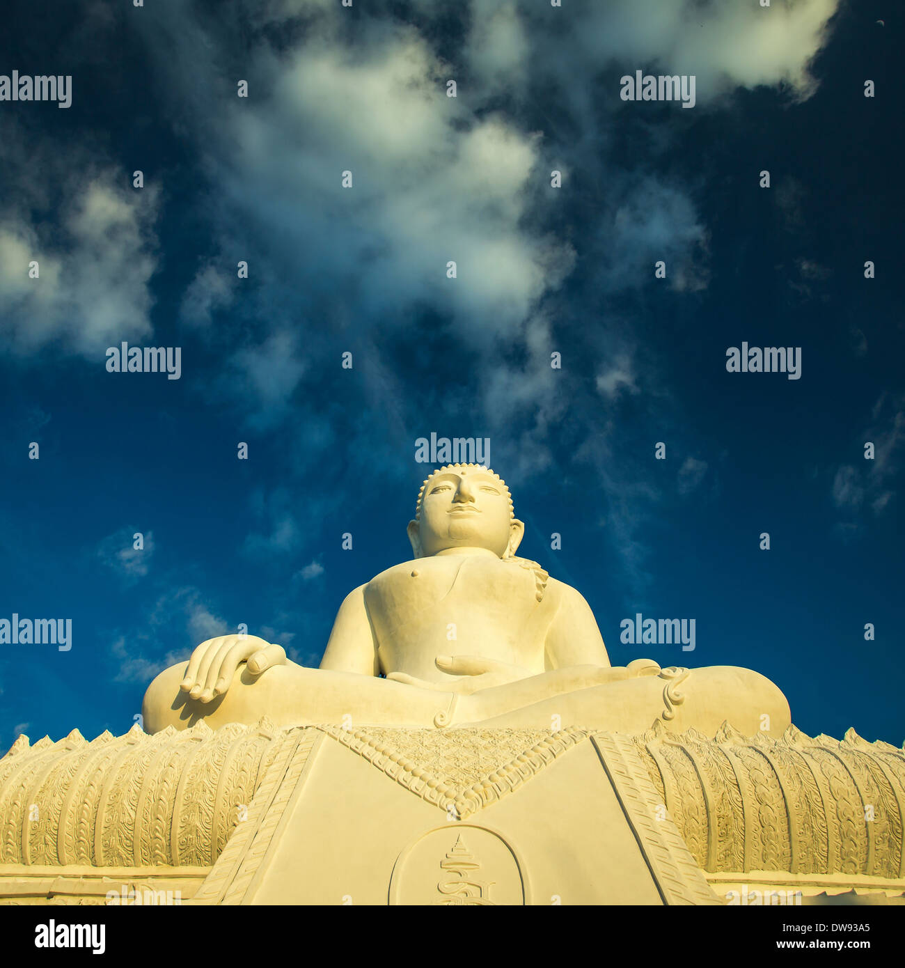 White Buddha statue against blue sky background Stock Photo