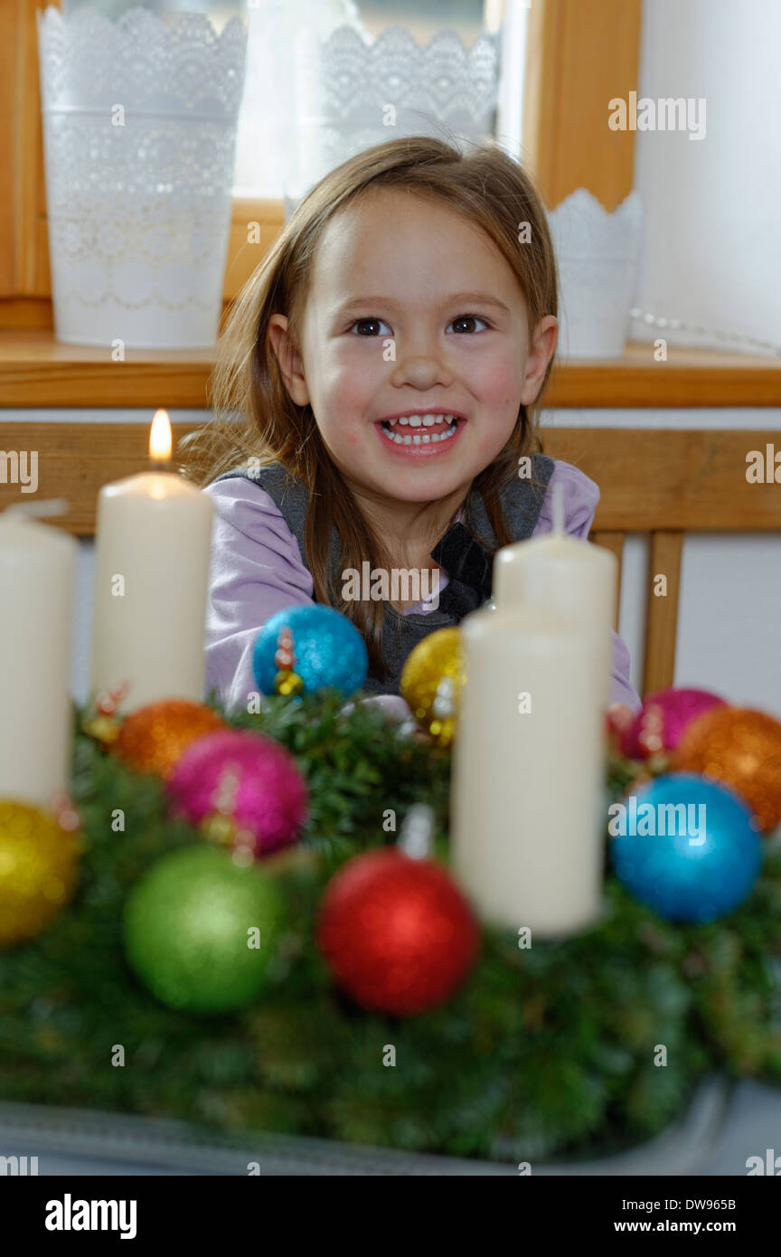 Girl enjoying the first lit candle on the Advent wreath Stock Photo