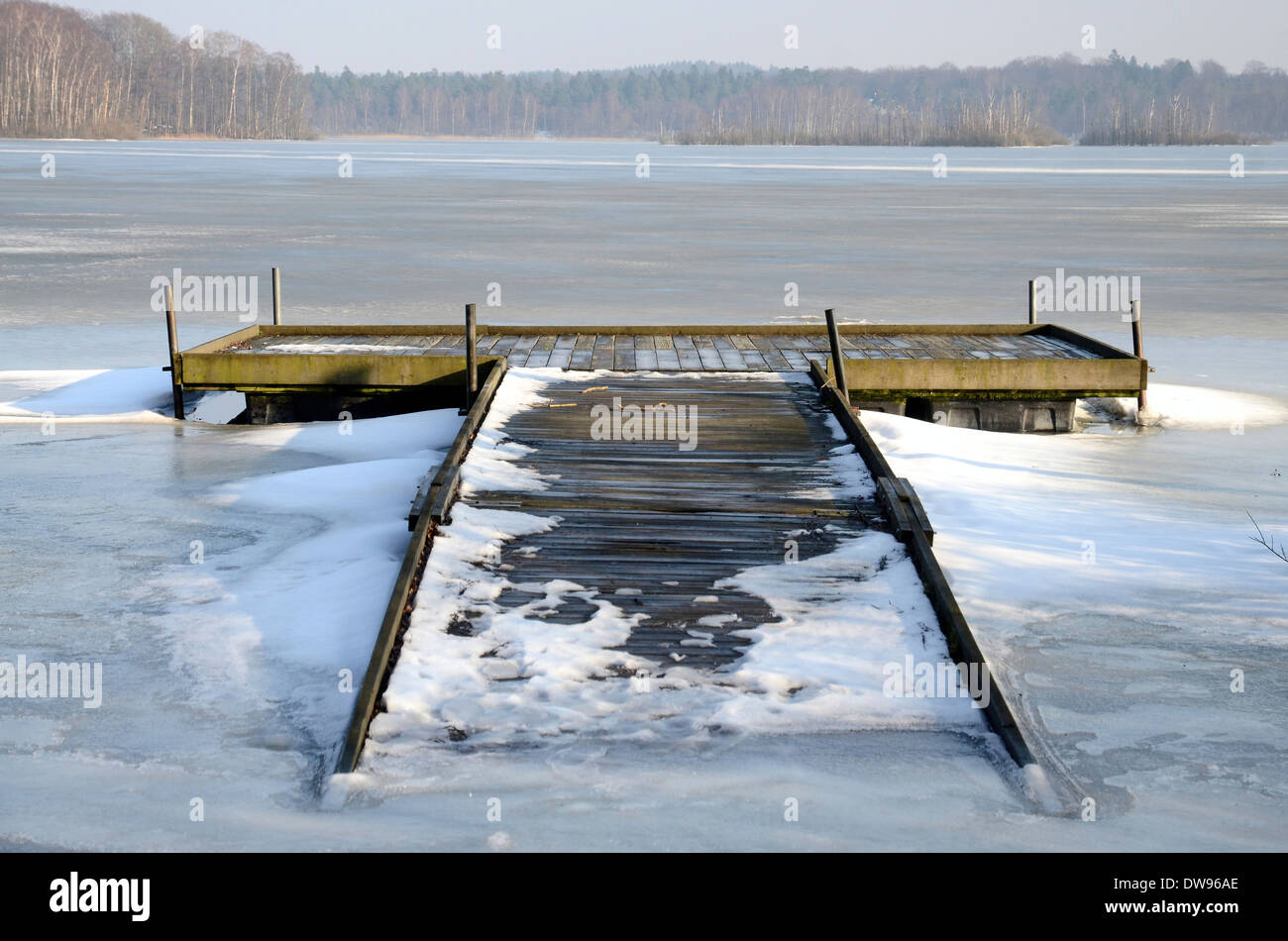 Bridge in ice on Snogeholmssjön lake, Skane, Sweden Stock Photo