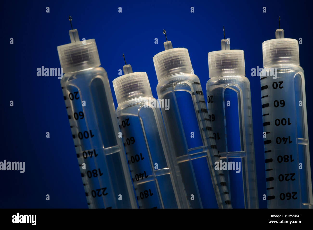 insulin injection pens on blue background Stock Photo