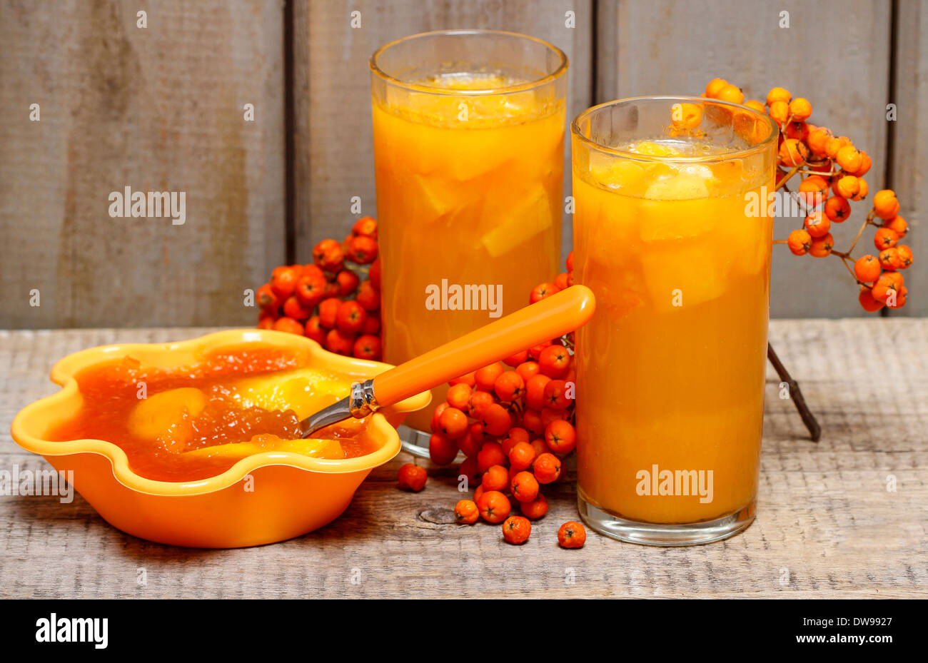 Orange juice and jelly dessert with apricots on wooden tableOrange